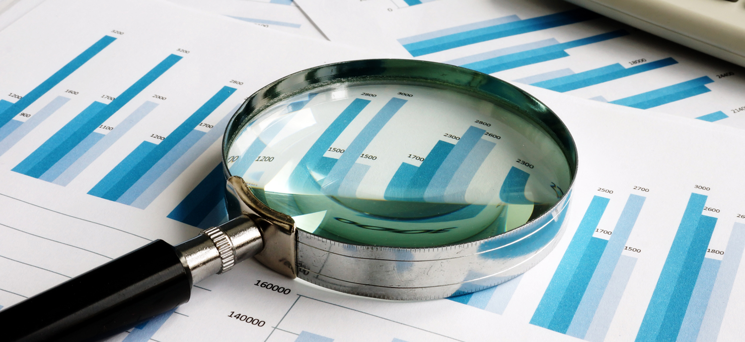Magnifying glass over financial documents